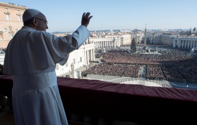 Pope Francis waves as he leads the "Urbi et Orbi" (to the city and the world) message from the balcony overlooking St. Peter's Square at the Vatican