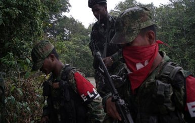 Rebels of Colombia's Marxist National Liberation Army get off a boat after patrolling the river, in the northwestern jungles