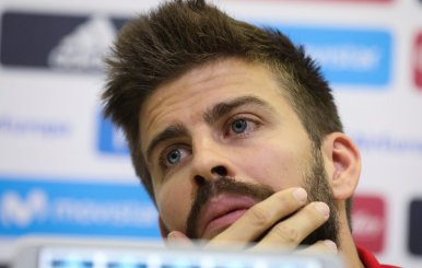 Spain's national soccer team player Gerard Pique gestures during a news conference at the training grounds in Las Rozas, outside Madrid