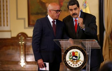 Venezuela's President Nicolas Maduro listens to Venezuela's Communications and Information Minister Jorge Rodriguez during a news conference in Caracas