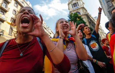 Women shout slogans against Spanish National Police during a gathering outside a National Police station, in Barcelona